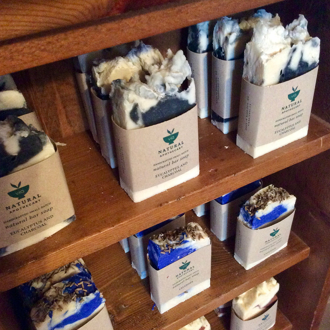 artisan soaps by via natural apothecary on a wooden shelf