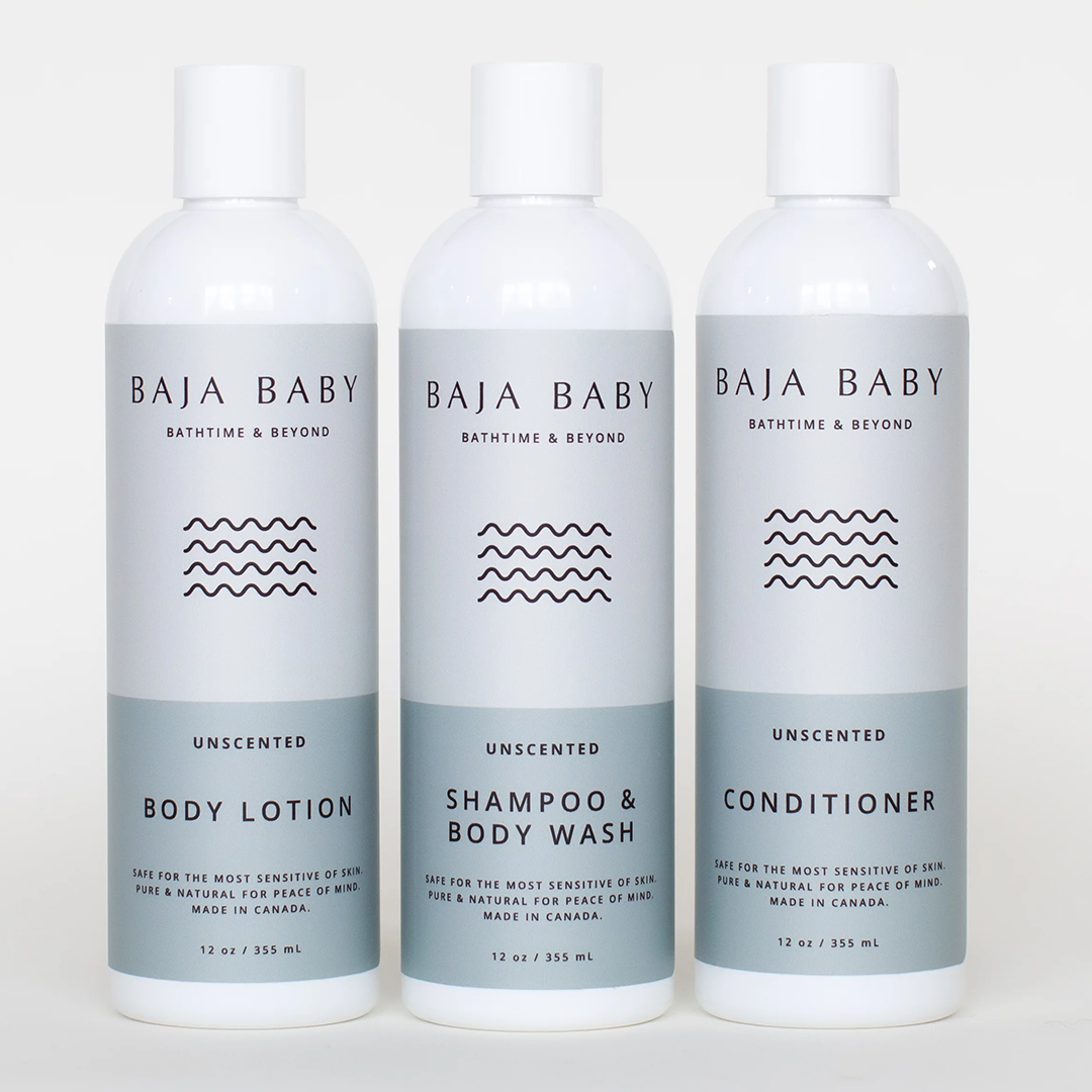 Three Baja Baby skincare products are displayed side by side against a white background. They are labeled as Body Lotion, Shampoo & Body Wash, and Conditioner. Each is unscented, safe for sensitive skin, made in Canada, and has a size of 12 oz or 355 mL.
