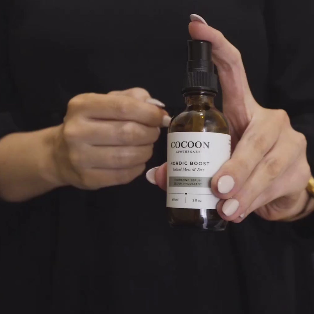 cocoon apothecary nordic boost hydrating serum being applied to a model's face