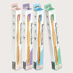 four tanit bamboo toothbrushes in pink purple blue and mint green